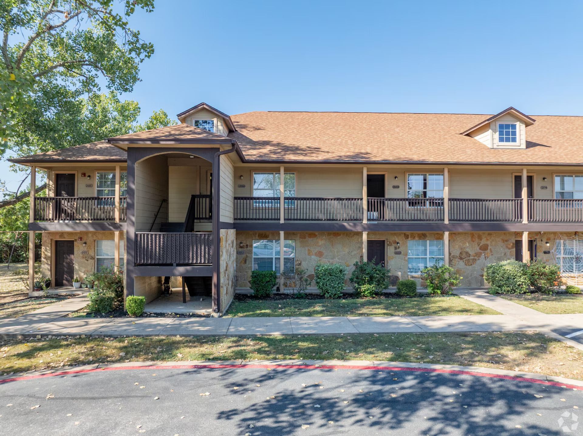 Front elevation with covered stair entry and upper walkways