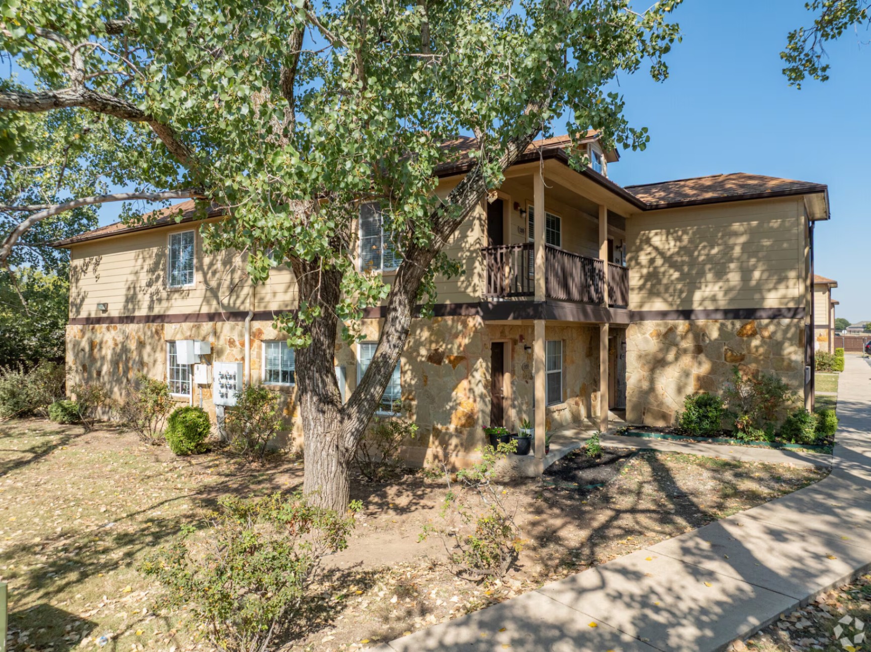 Front corner building with mature shade trees