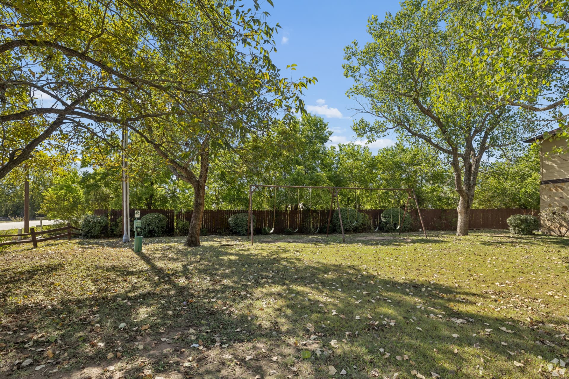 Community swings and green space under shade trees