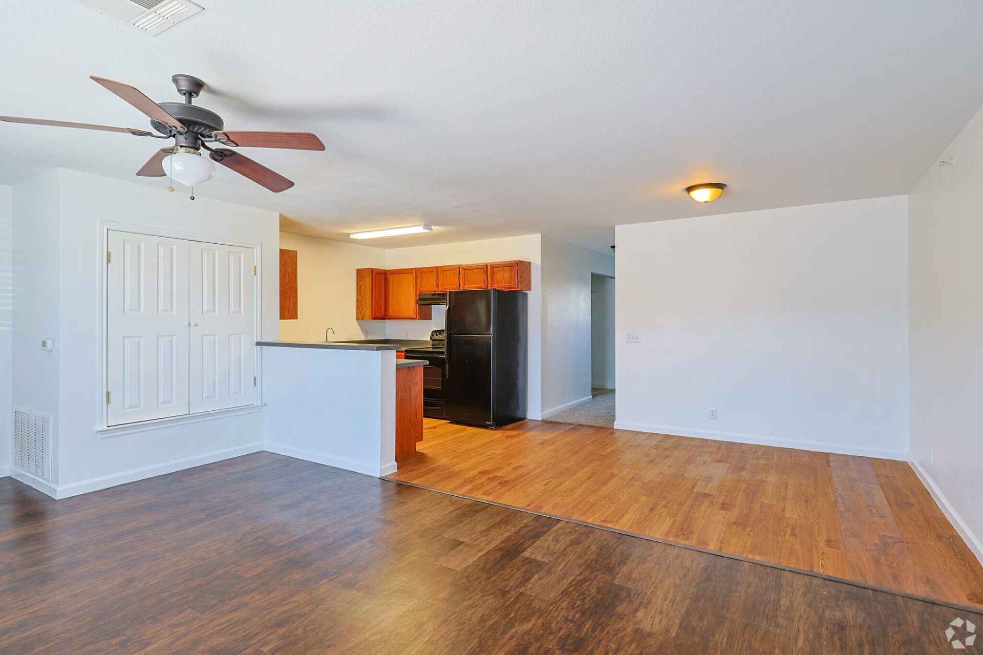 Classic-finish open living and kitchen layout with oak cabinets and wood-look flooring
