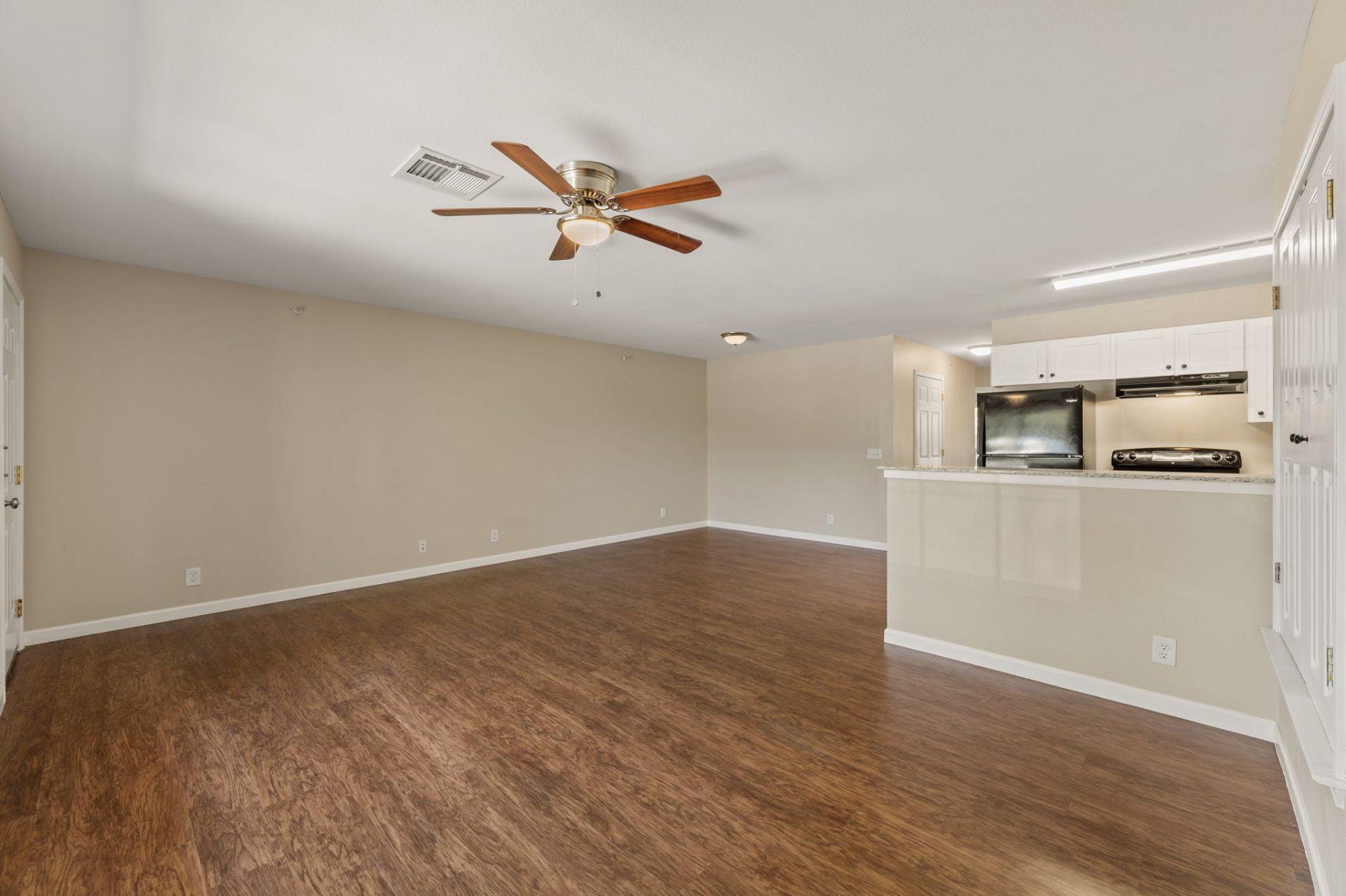Spacious living room opening to the kitchen breakfast bar